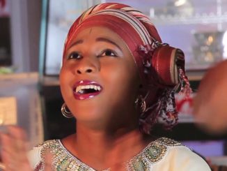 Shareef Ummanchira - Maryama a woman with red lipstick and red head wrap